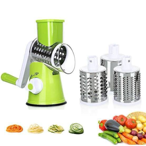 Green manual vegetable spiralizer with three attachments on a white background