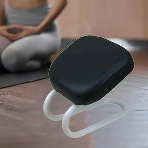 Black and white cushion on a wooden surface with a blurred person in the background.