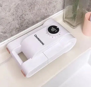 White handheld device with digital display on a bathroom counter