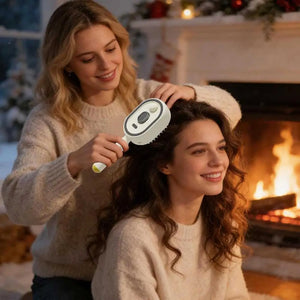 Two women in cozy sweaters with a hairbrush in front of a fireplace.