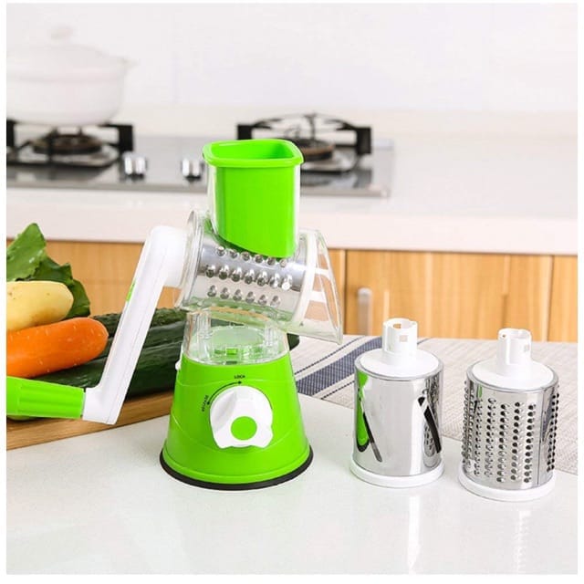 Green kitchen tool on a counter with vegetables in the background