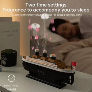 Fragrance diffuser shaped like a ship with a person sleeping in the background